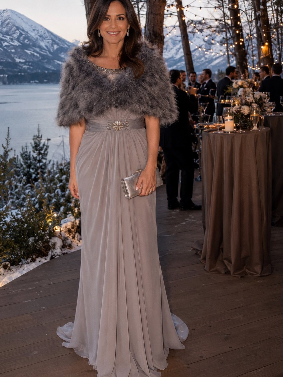 Woman wearing a long grey formal dress and a grey faux fur shrug outdoors.